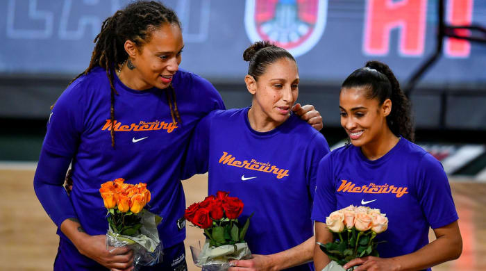 Brittney Griner, Diana Taurasi, and Skylar Diggins-Smith holding flowers